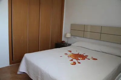a bedroom with a white bed with a crab on it at Apartamento Playa Moncofar - Xilxes in Moncófar