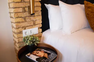 a table with a picture on it next to a bed at Voghe Premium Flats in Valencia