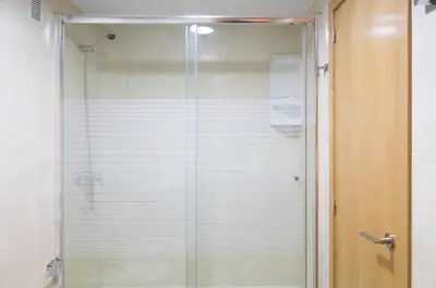 a shower with a glass door in a bathroom at Central Station. Free Wifi & Terrace in Valencia