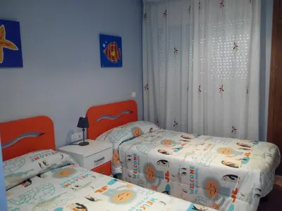 two twin beds in a room with two at RELAX, MAR Y MONTAÑA in Tavernes de Valldigna