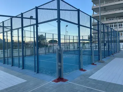 a tennis court with a net on a tennis court at RELAX, MAR Y MONTAÑA in Tavernes de Valldigna