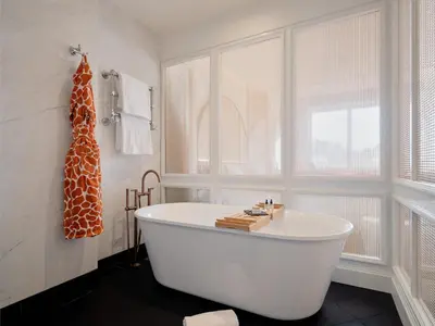 a white bath tub in a bathroom with a window at Only YOU Hotel Valencia in Valencia
