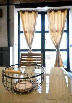 a table and chairs in front of a window at Casita en el Cabañal con Patio in Valencia