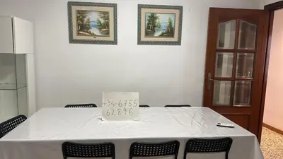 a room with a table with a price sign on it at Alquiler universidades malvarrosa Playa Maritim Valencia in Valencia