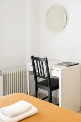 a table with a chair and a desk with a mirror at Hideout 26 in Valencia