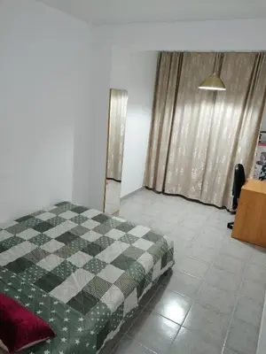 a bedroom with a bed in a room with a window at Fully Furnished Double Room in Valencia