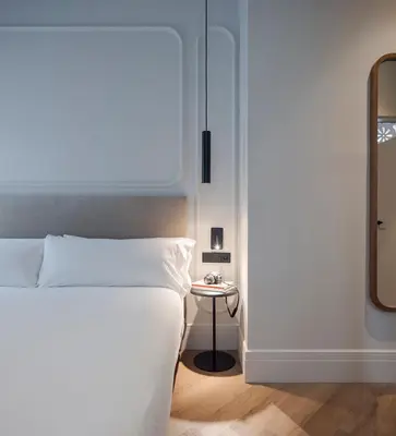 a bedroom with a bed and a side table at Room Mate Oliveira - City Centre, Valencia in Valencia