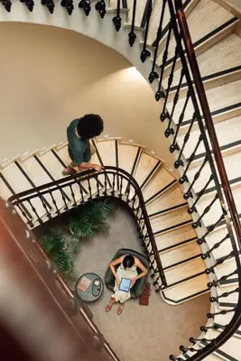 a view of a spiral staircase with a man and a woman at Room Mate Oliveira - City Centre, Valencia in Valencia