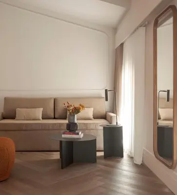 a living room with a couch and a table at Room Mate Oliveira - City Centre, Valencia in Valencia
