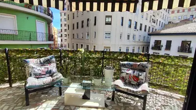 a balcony with a glass table and two chairs at Terrasa de Mercado Central in Valencia