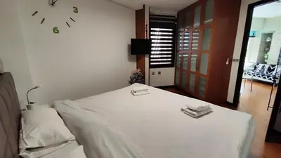a bedroom with a bed with a clock on the wall at Terrasa de Mercado Central in Valencia
