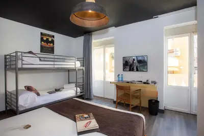 a bedroom with two bunk beds and a desk at Casual del Cine Valencia in Valencia