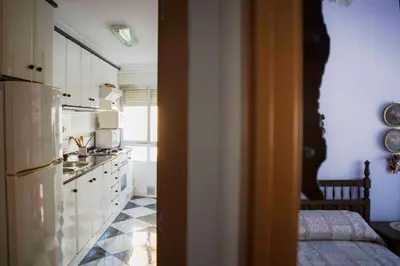 a kitchen with a refrigerator and a counter top at Bonito apartament a 3 minutos de la playa in Cullera