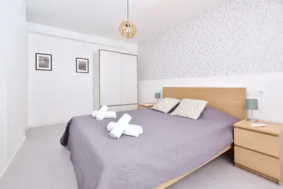 a bedroom with a purple bed with two pillows at Emma Apartment Central in Valencia