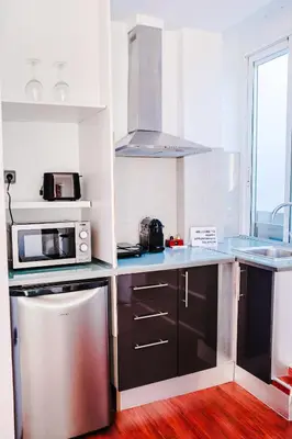 a kitchen with a sink and a microwave at Happy Apartments Valencia – Lope de Vega in Valencia