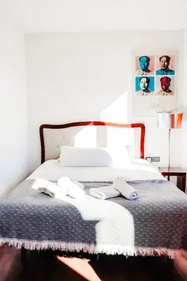 a bedroom with a bed with two slippers on it at Happy Apartments Valencia – Lope de Vega in Valencia