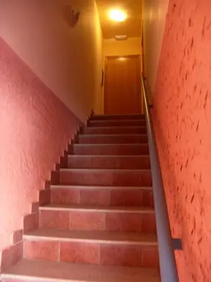 a set of stairs in a building with a red wall at Valle del Nilo in Ventas de Poyo