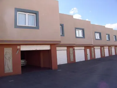 a row of garages in front of a building at Valle del Nilo in Ventas de Poyo
