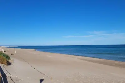an empty beach with the ocean in the background at Beachfront House, Valencia, Wifi, Paddle Surf Board, Incredible Views in Sueca