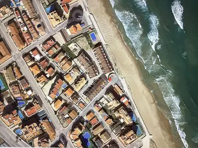 an overhead view of a beach with buildings and the water at Beachfront House, Valencia, Wifi, Paddle Surf Board, Incredible Views in Sueca