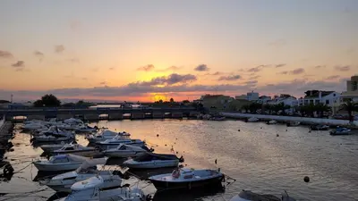 a group of boats docked in a harbor at sunset at Beachfront House, Valencia, Wifi, Paddle Surf Board, Incredible Views in Sueca