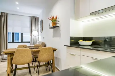 a kitchen and dining room with a table and chairs at Goerlich by Alma Suites in Valencia