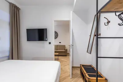 a bedroom with a bed and a tv on a wall at Goerlich by Alma Suites in Valencia