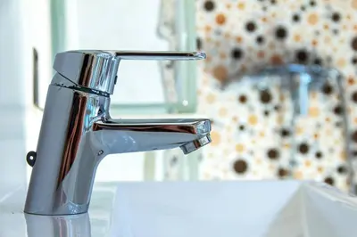 a silver faucet on a sink in a bathroom at Acogedor Dúplex con terraza interior en la playa in Valencia