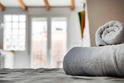 a rolled up towel on top of a bed at Estudio para parejas con terraza en la playa in Valencia