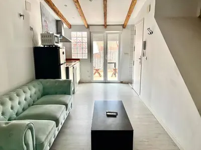 a living room with a couch and a coffee table at Estudio para parejas con terraza en la playa in Valencia