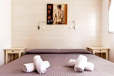 a bedroom with a bed with towels on it at Apartamento con terraza privada cerca de la playa in Valencia