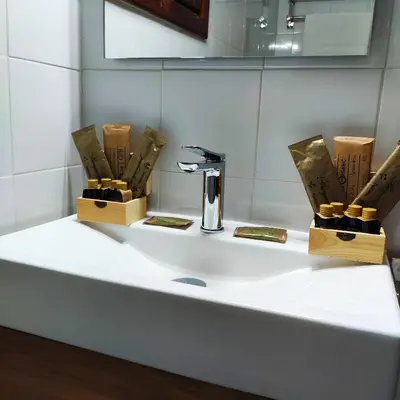 a white bathroom sink with a faucet and wooden boxes at Pago de Tharsys in Requena