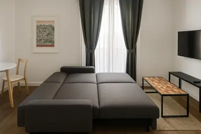 a living room with a couch with pillows on it at AmazINN Collection Valencia Centro EVI in Valencia