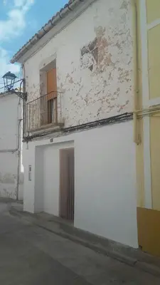 a white building with a door and a balcony at Casa Blanca in Algimia de Alfara
