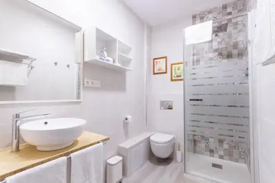 a white bathroom with a sink and a toilet at A Casa Martínez B&B in Valencia