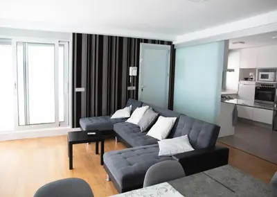 a living room with a couch and a table at Apartamentos turísticos Cullera in Faro de Cullera
