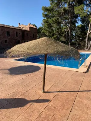 a kitchen and living room with a couch and a table at Masia de San Juan - castillo con piscina en plena Sierra Calderona in Segorbe