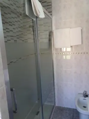 a bathroom with a shower and a toilet at Hostal La Pilarica in Paterna