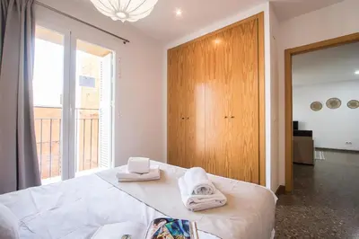 a bedroom with a bed with towels on it at Apartamentos Carmen in Valencia