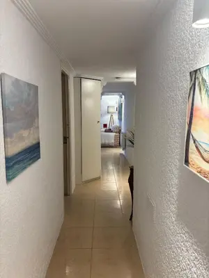 a hallway leading to a room with a bedroom at LEMON TREE VILLA in Monserrat
