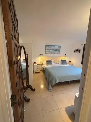 a bedroom with a bed with a blue comforter at LEMON TREE VILLA in Monserrat