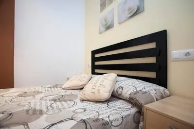 a bedroom with a bed with two pillows on it at Casita privada con encanto en la playa de Valencia in Valencia