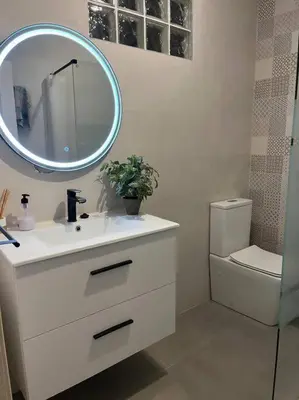 a bathroom with a sink and a mirror and a toilet at Casita privada con encanto en la playa de Valencia in Valencia