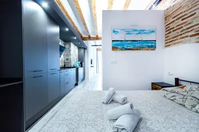a bedroom with a large bed with two pillows on it at Chic estudio privado al lado de la playa in Valencia
