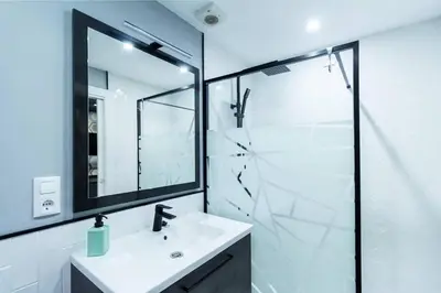 a white bathroom with a sink and a shower at Chic estudio privado al lado de la playa in Valencia