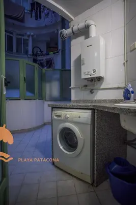 a washer and dryer in a room at Front Sun Beach Apartment in Valencia