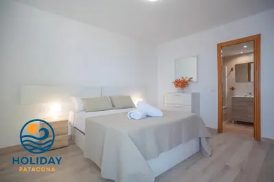 a bedroom with two beds and a bathroom at Front Sun Beach Apartment in Valencia