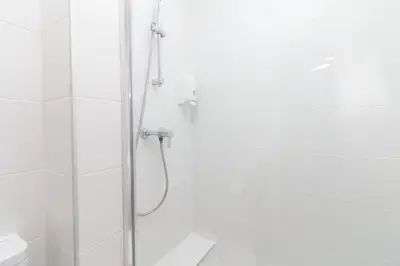a white bathroom with a shower and a toilet at BET Apartments - Reig in Valencia
