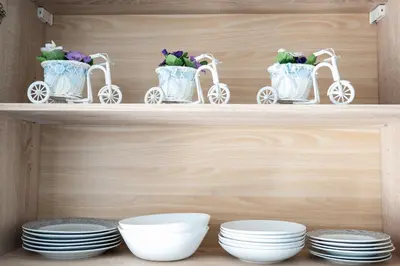 a wooden shelf with white dishes and white plates at Versus Apartment City Center in Valencia