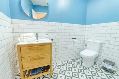 a bathroom with a toilet and a sink and a mirror at Beams & Bricks in Valencia
